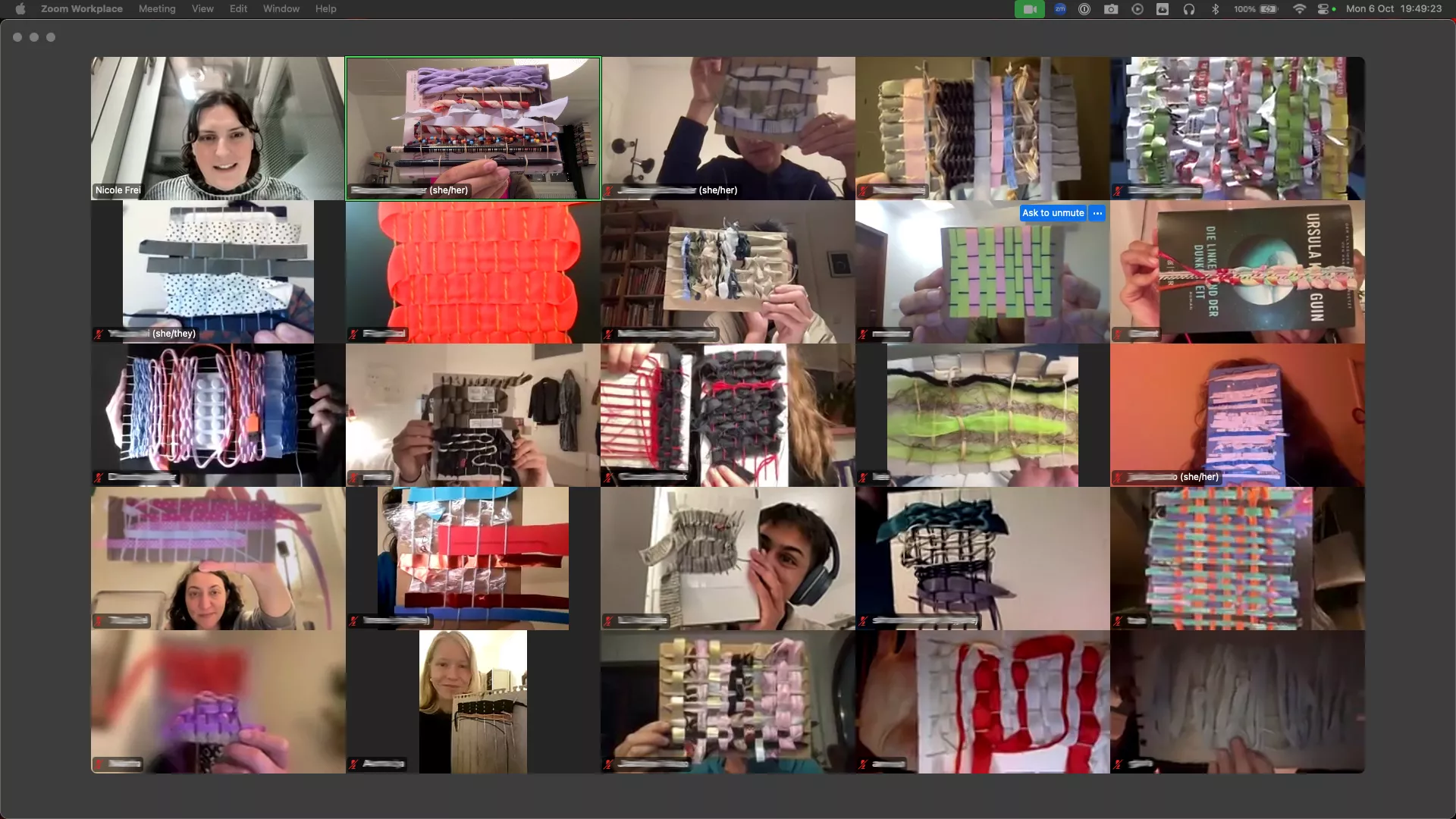 Screenshot of an online meeting in gallery view. Around twenty participants are shown, many holding up handmade woven samples made from paper, fabric strips, cords, and other materials. The samples vary in colour, texture, and structure, including grids, layered strips, loops, pleats, and bright woven patterns. One participant appears in the top left, while most other tiles focus on the woven pieces being presented.