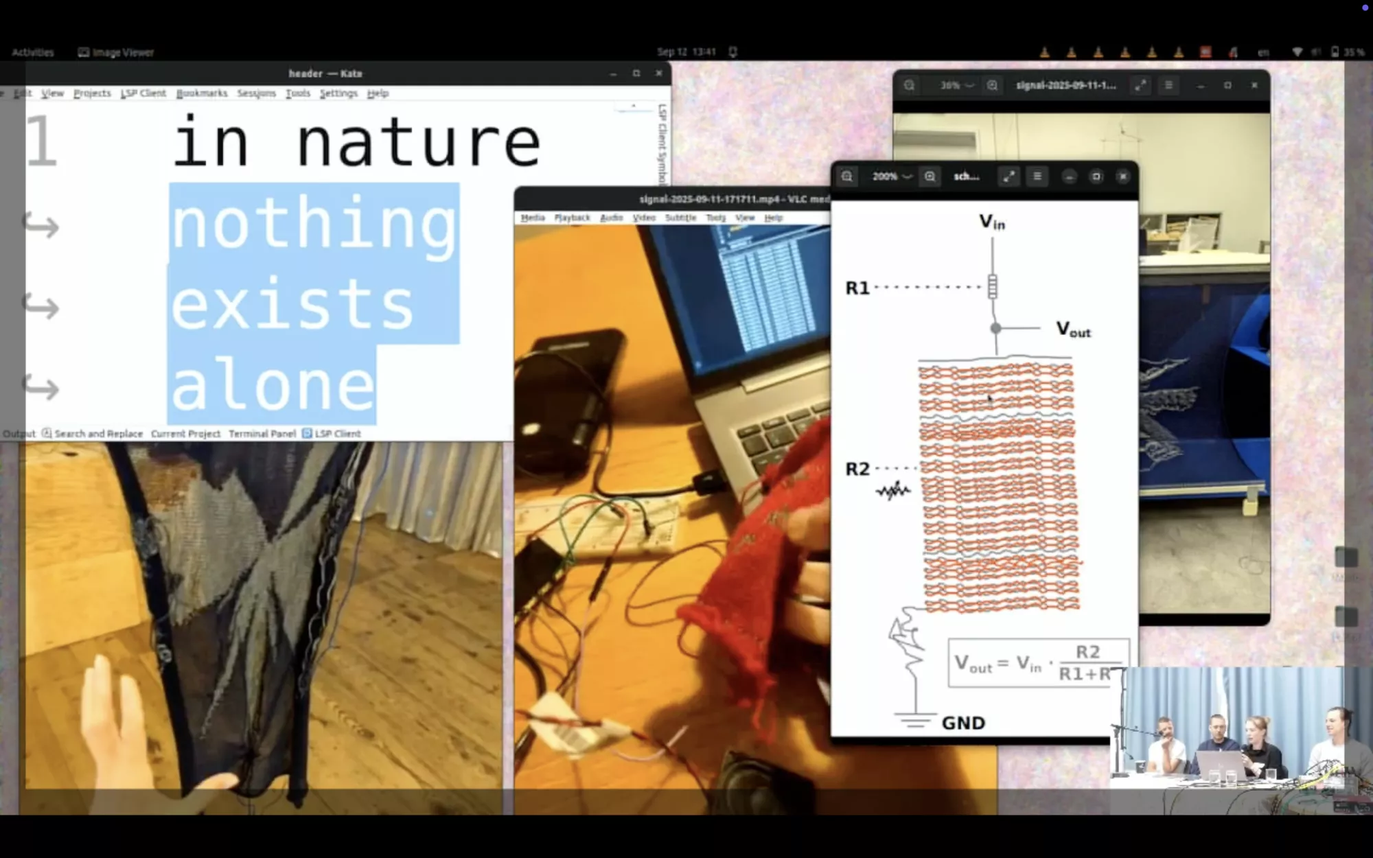 A Screenshot of the presentation at the algorythmic patterns conference. A digital desktop is shown with several overlapping media windows related to textile and electronic experiments. One window contains large text reading “in nature nothing exists alone.” Other windows show a hand interacting with a dark hanging textile, a close-up of electronic cables and a red textile sample on a desk, and a technical diagram of a circuit combined with a woven structure. In the bottom right corner, a small video inset shows four people seated at a table during a presentation or discussion.